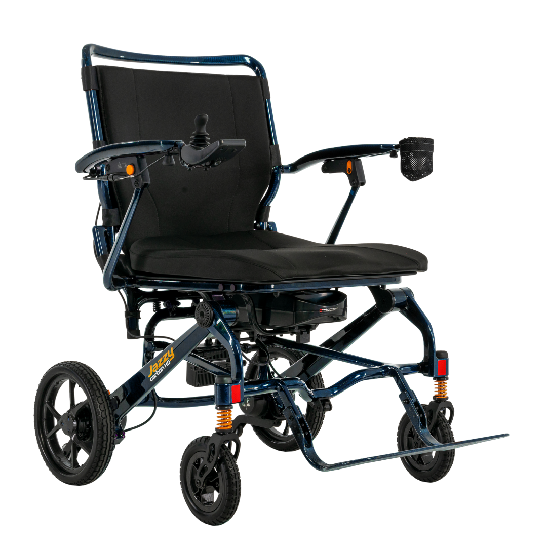 The Pride Jazzy Carbon HD Bariatric Portable Powerchair features a modern, sturdy frame, black cushioned seat, joystick armrest control, footrest, rear/front wheels, and a right-arm cup holder—perfect for easy travel.